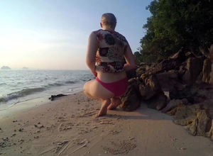 Obese maiden draining on the beach